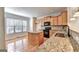 Eat-in kitchen, granite counters, wood cabinets at 2790 Laurel Valley Trail, Buford, GA 30519