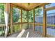 Relaxing screened porch with wooden flooring and access to a deck at 2790 Laurel Valley Trail, Buford, GA 30519