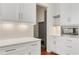 White kitchen cabinets with a built-in microwave and gray pantry at 600 Autumn Ln, Marietta, GA 30068