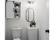 Basement powder room with pedestal sink and barn door cabinet at 607 Ann Ct, Woodstock, GA 30188