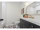 Stylish bathroom with dark vanity, patterned tile floor, and gold accents at 607 Ann Ct, Woodstock, GA 30188