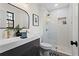 Modern bathroom with double vanity, gold fixtures, and a glass shower at 607 Ann Ct, Woodstock, GA 30188