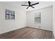 Bright bedroom featuring hardwood floors and ceiling fan at 607 Ann Ct, Woodstock, GA 30188