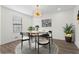 Modern dining room with round table and statement chandelier at 607 Ann Ct, Woodstock, GA 30188