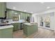 Modern kitchen with green cabinets, island, and stainless steel appliances at 607 Ann Ct, Woodstock, GA 30188