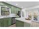 Modern kitchen with green cabinets, island, and stainless steel appliances at 607 Ann Ct, Woodstock, GA 30188