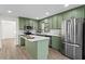 Modern kitchen with green cabinets, island, and stainless steel appliances at 607 Ann Ct, Woodstock, GA 30188