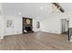 Living room with fireplace, hardwood floors, and high ceilings at 607 Ann Ct, Woodstock, GA 30188