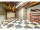 Basement garage with checkered floor and ample storage at 1150 Brushy Mountain Rd, Rockmart, GA 30153