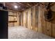 Rustic basement room with wood walls, shelving, and carpeting at 1150 Brushy Mountain Rd, Rockmart, GA 30153