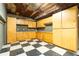 Basement workshop with wood cabinets and checkered flooring at 1150 Brushy Mountain Rd, Rockmart, GA 30153