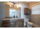 Bathroom with granite countertop, wood cabinets, and shower/tub at 1150 Brushy Mountain Rd, Rockmart, GA 30153