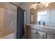 Modern bathroom with granite vanity, wood cabinets, and shower at 1150 Brushy Mountain Rd, Rockmart, GA 30153