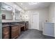 Elegant bathroom with double sinks, dark brown cabinets, and gray tile floors at 1150 Brushy Mountain Rd, Rockmart, GA 30153