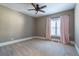 Bright bedroom featuring light walls, carpeted floors, and pink curtains at 1150 Brushy Mountain Rd, Rockmart, GA 30153