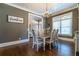 Farmhouse-style dining room with hardwood floors and chandelier at 1150 Brushy Mountain Rd, Rockmart, GA 30153