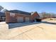 Three-car garage with a basketball goal and large driveway at 1150 Brushy Mountain Rd, Rockmart, GA 30153