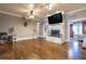 Living room with hardwood floors, fireplace, and large TV at 1150 Brushy Mountain Rd, Rockmart, GA 30153