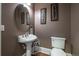 Elegant powder room with pedestal sink and decorative wall art at 1150 Brushy Mountain Rd, Rockmart, GA 30153