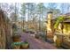 Landscaped backyard path with large clay pots and wood fence, leading to home at 1605 Brandon Hall Dr, Atlanta, GA 30350