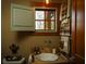 Rustic bathroom with vintage sink, wood accents, and a window with shutters at 1605 Brandon Hall Dr, Atlanta, GA 30350