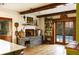 Rustic kitchen features a wood-burning fireplace and French doors at 1605 Brandon Hall Dr, Atlanta, GA 30350