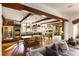 Open concept kitchen with exposed beams, farmhouse table, and green cabinetry at 1605 Brandon Hall Dr, Atlanta, GA 30350