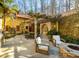 Private patio with a stone fireplace, pergola, and built-in seating at 1605 Brandon Hall Dr, Atlanta, GA 30350