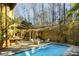 Gorgeous pool area with stone wall and outdoor seating at 1605 Brandon Hall Dr, Atlanta, GA 30350