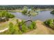 Aerial view of a golf course community with a lake and bridge at 5008 Cambridge Ln, Villa Rica, GA 30180