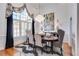 Formal dining room with hardwood floors, large window, and elegant chandelier at 5008 Cambridge Ln, Villa Rica, GA 30180