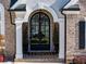 Elegant arched front door with black frame and sidelights at 5008 Cambridge Ln, Villa Rica, GA 30180