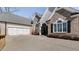 Two-car garage with white doors and brick exterior at 5008 Cambridge Ln, Villa Rica, GA 30180