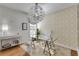 Bright home office with glass desk, patterned wallpaper, and hardwood floors at 5008 Cambridge Ln, Villa Rica, GA 30180