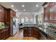 Modern kitchen with dark wood cabinets, granite countertops, and stainless steel appliances at 5008 Cambridge Ln, Villa Rica, GA 30180