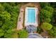 Aerial view of community pool with lap lanes, playground, and surrounding trees at 5008 Cambridge Ln, Villa Rica, GA 30180