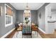 Elegant dining room with hardwood floors, chandelier, and gray walls at 141 Northcutt Sw St, Marietta, GA 30064