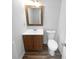 Simple bathroom with wood vanity and updated toilet at 2190 Wellington Cir, Lithonia, GA 30058