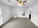 Bright bedroom with carpeting, ceiling fan and access to a private bathroom at 2190 Wellington Cir, Lithonia, GA 30058