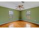 Bedroom with hardwood floors and two windows at 52 Darby Rd, Covington, GA 30016