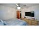 Large bedroom with king bed, TV, and ceiling fan at 750 Skipper Dr, Atlanta, GA 30318