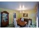 Elegant dining room with a wood table, chandelier, and built-in hutch at 750 Skipper Dr, Atlanta, GA 30318