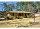 Brick ranch house with a landscaped lawn and mature trees at 750 Skipper Dr, Atlanta, GA 30318