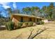Brick ranch house with a landscaped lawn and mature trees at 750 Skipper Dr, Atlanta, GA 30318