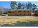 Brick house exterior with large backyard and mature trees at 750 Skipper Dr, Atlanta, GA 30318