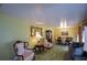 Bright living room with green carpet, comfortable seating, and a formal dining area at 750 Skipper Dr, Atlanta, GA 30318