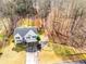 Aerial view of home featuring the front yard, driveway, and surrounding trees at 2205 Castle Royale Dr, Lawrenceville, GA 30043