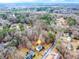 An aerial view of a home nestled among mature trees in a quiet, established neighborhood at 2205 Castle Royale Dr, Lawrenceville, GA 30043
