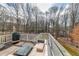 Back deck features outdoor seating, grill and wooded views for outdoor enjoyment and relaxation at 2205 Castle Royale Dr, Lawrenceville, GA 30043