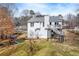 View of home from spacious backyard featuring a deck and playset at 2205 Castle Royale Dr, Lawrenceville, GA 30043